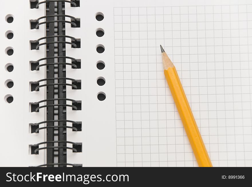 Blank spiral notebook with yellow pencil