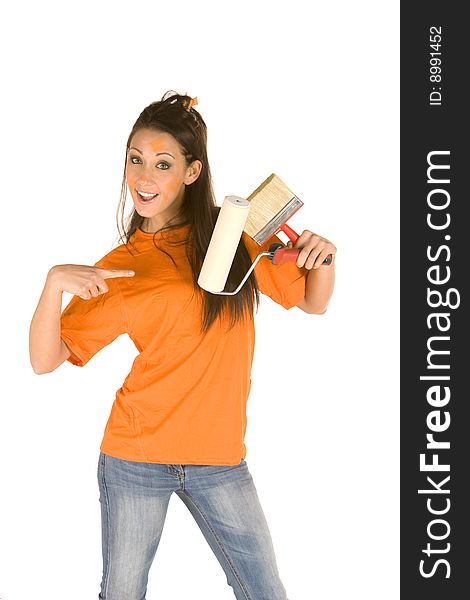 Young caucasian brunette holding a brush with orange t-shirt and orange paint on her face,making facial expression. Young caucasian brunette holding a brush with orange t-shirt and orange paint on her face,making facial expression