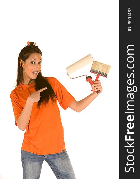 Young caucasian brunette holding a brush with orange t-shirt and orange paint on her face,making facial expression. Young caucasian brunette holding a brush with orange t-shirt and orange paint on her face,making facial expression