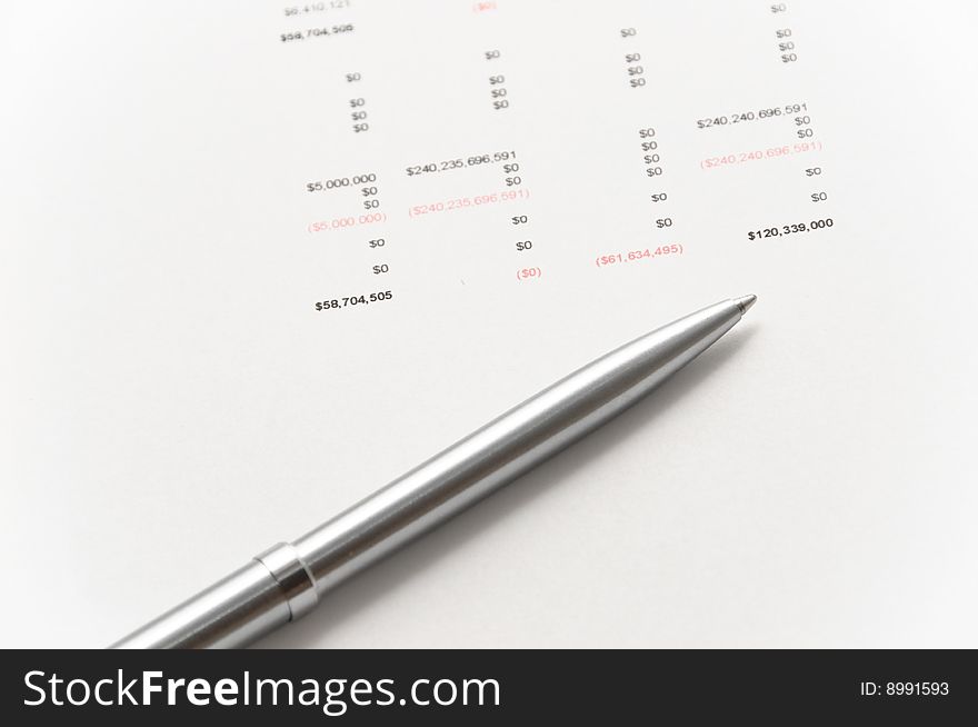 Elegant silver pen on financial balance sheet. Elegant silver pen on financial balance sheet