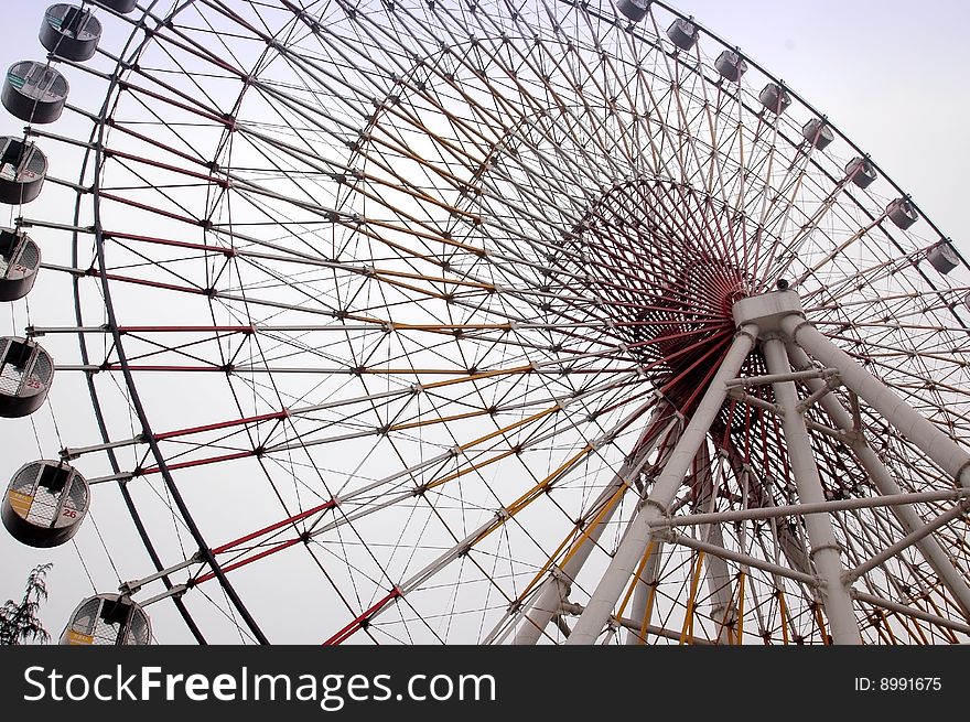 A huge ferris wheel in the  fairground. A huge ferris wheel in the  fairground