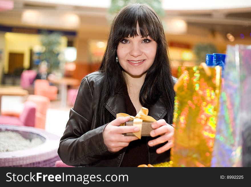 Happy brunette woman in shopping mall. Happy brunette woman in shopping mall