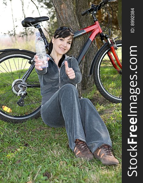 Happy woman with bike in park. Happy woman with bike in park
