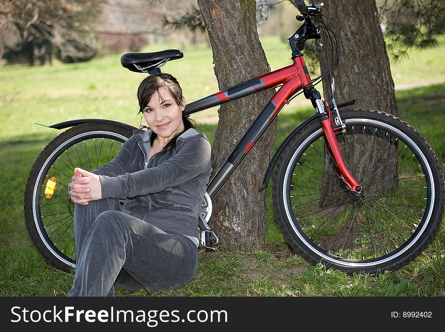 Happy woman with bike in park. Happy woman with bike in park