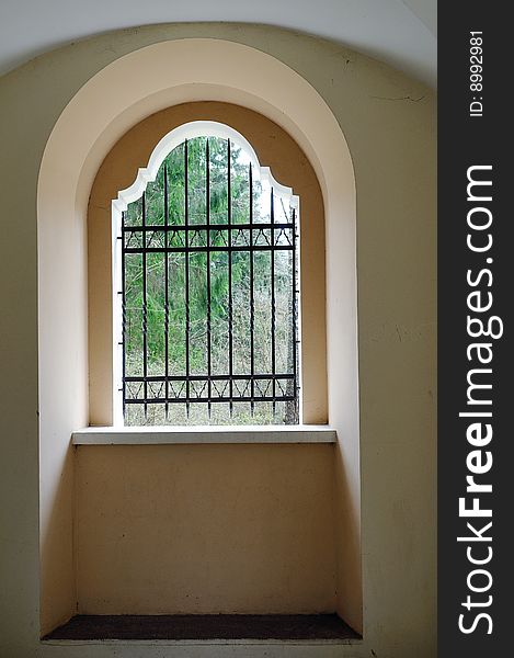 Catholic religious construction. Metal lattice at a window