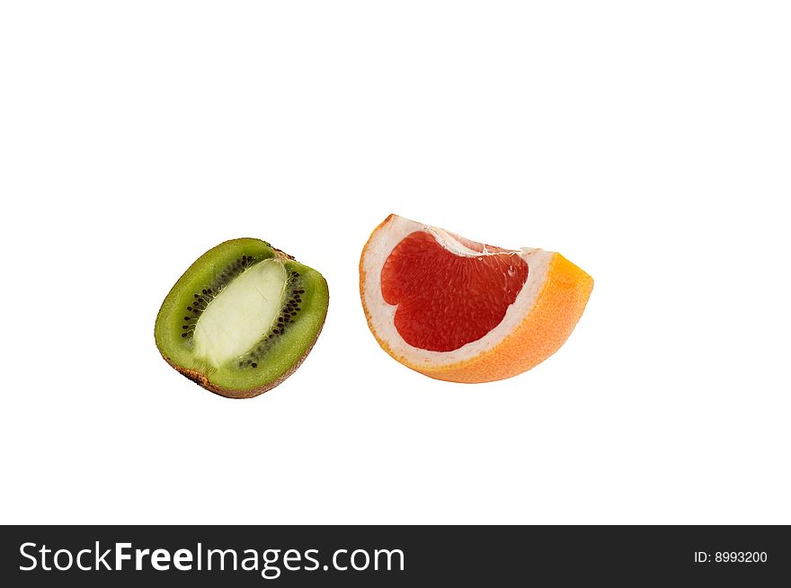 Pieces of juicy kiwi and grapefruit on a white.