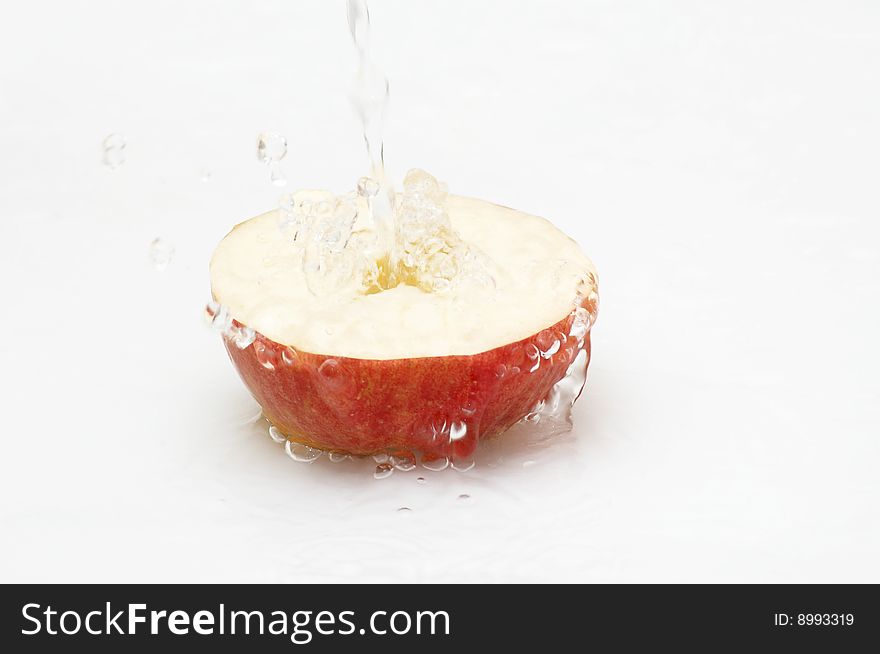 Fresh water falling on an apple.