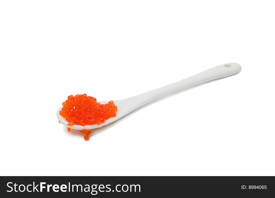 The spoon with caviar. Isolated on white.