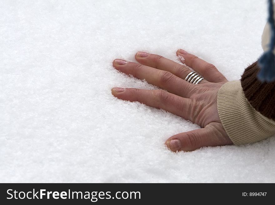Five fingers or hand with ring lays on cold snow. Five fingers or hand with ring lays on cold snow