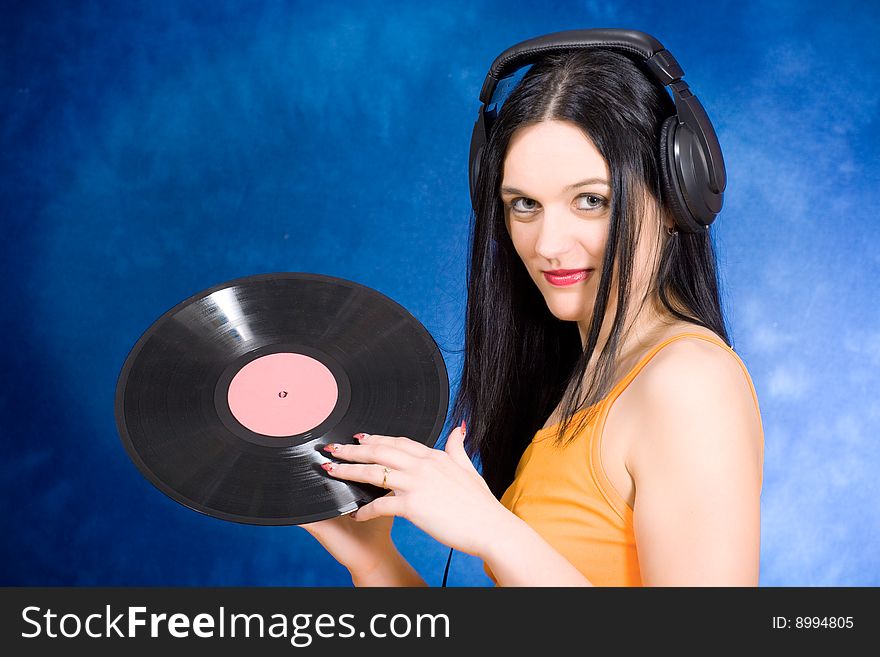 Portrait of the beautiful girl in headphones with vinyl. Portrait of the beautiful girl in headphones with vinyl