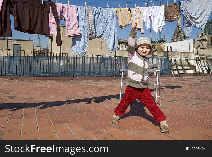 Portrait of a sweet girl with the clothesline. urban scene
