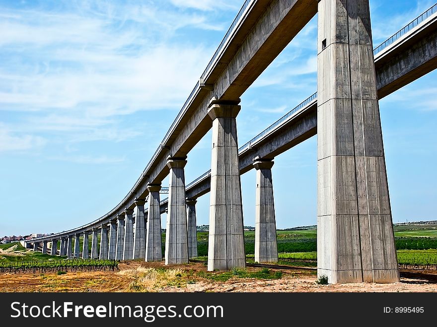 A huge high concrete train bridge under construction.