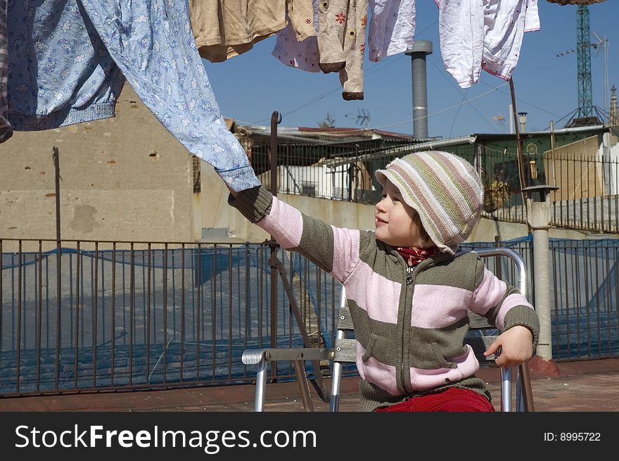 Portrait of a sweet girl with the clothesline. urban scene
