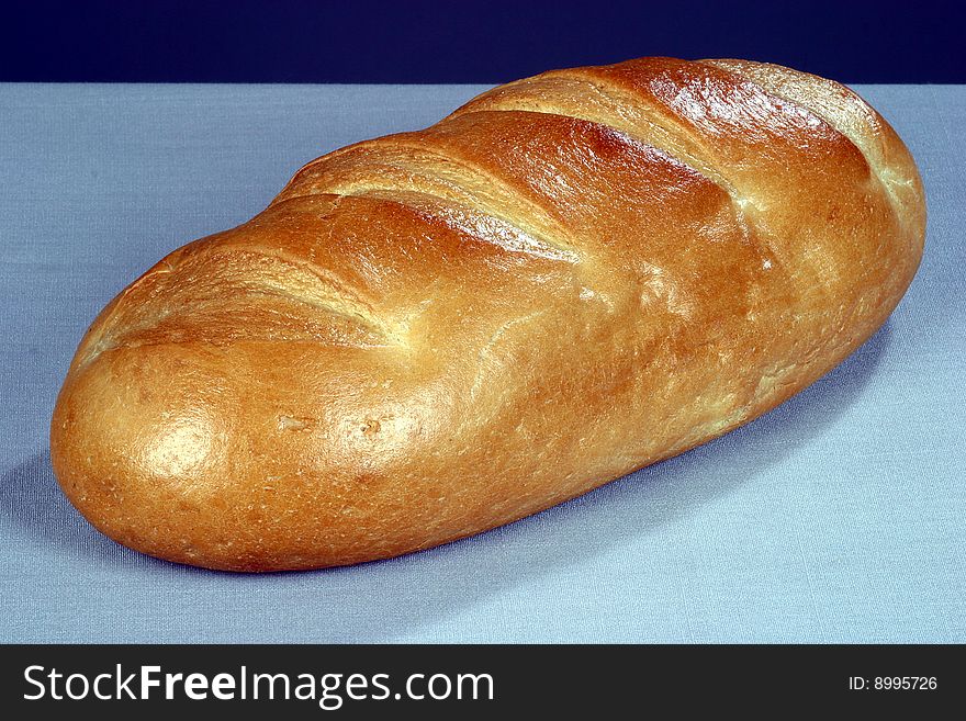 Baked loaf of bread on light background