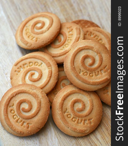 A bunch of yoghurt biscuits on a wooden chopping board