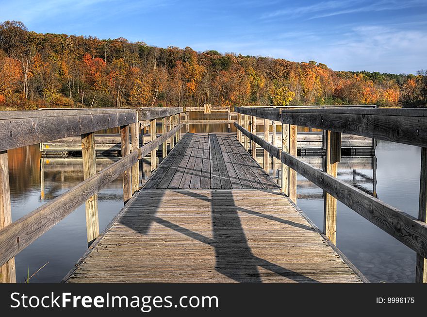 Autumn Dock - close up of dock on lake with autumn trees