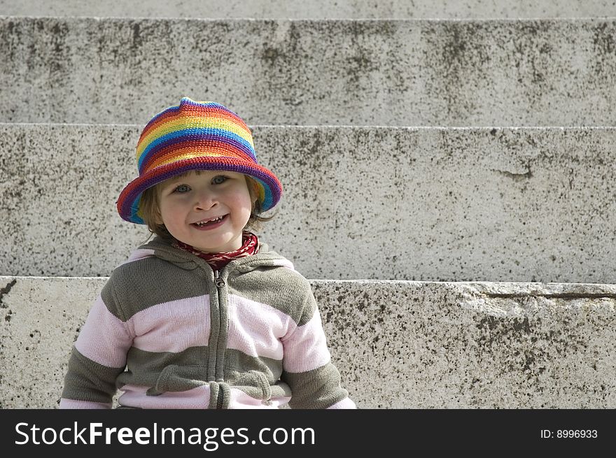 Portrait of a sweet girl sitting on the steps