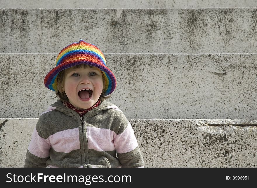 Portrait of a sweet girl sitting on the steps