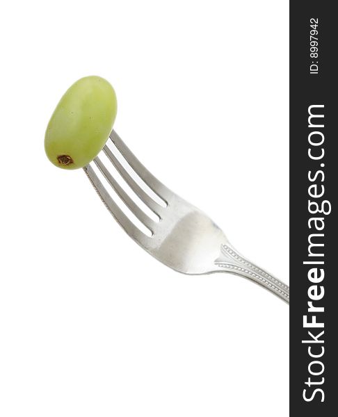 A fork with a grape on it to show healthy eating. A fork with a grape on it to show healthy eating.