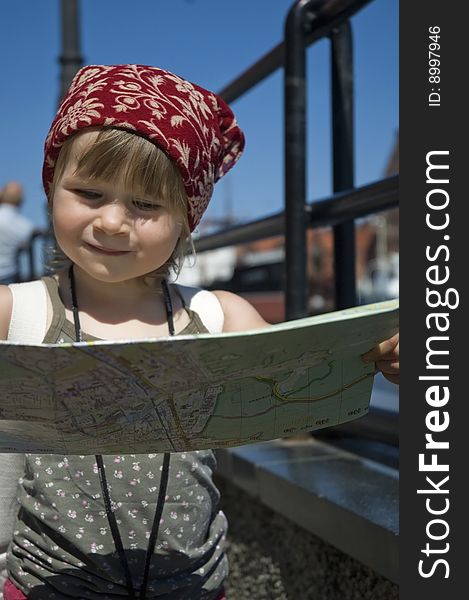 Little girl with a city map. travel