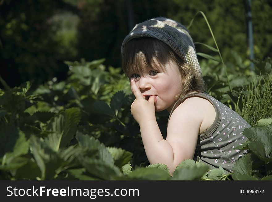 Two-year-old girl enjoying a fresh fruit. Two-year-old girl enjoying a fresh fruit