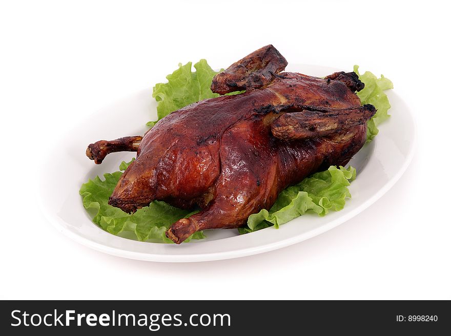 Fried duck on a dish with salad