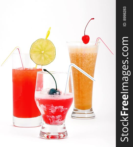 Beautiful fruit cocktails with ice, a cherry and a lemon