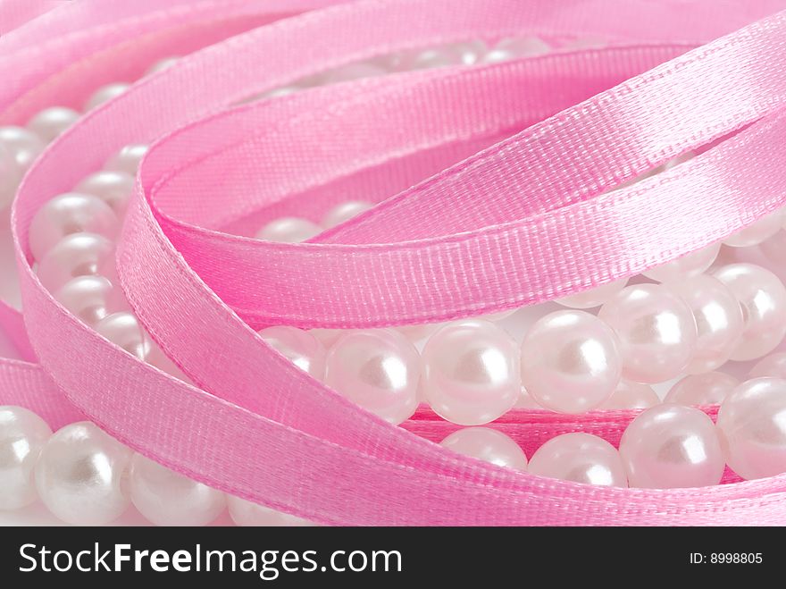 Pearls and satin pink ribbon. Pearls and satin pink ribbon