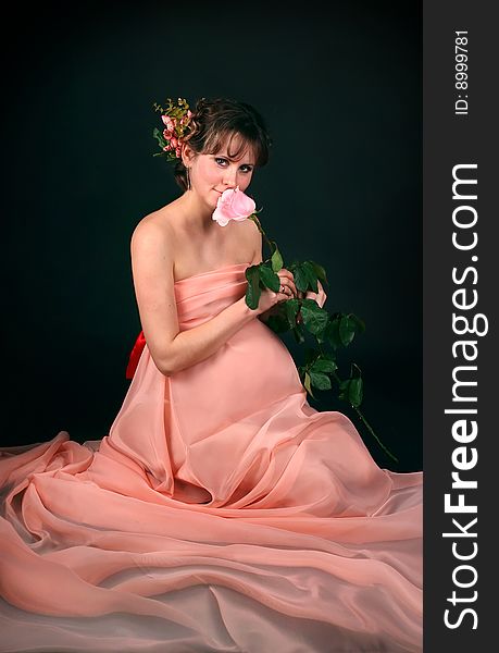 Pregnant woman on dark background. New photos every week