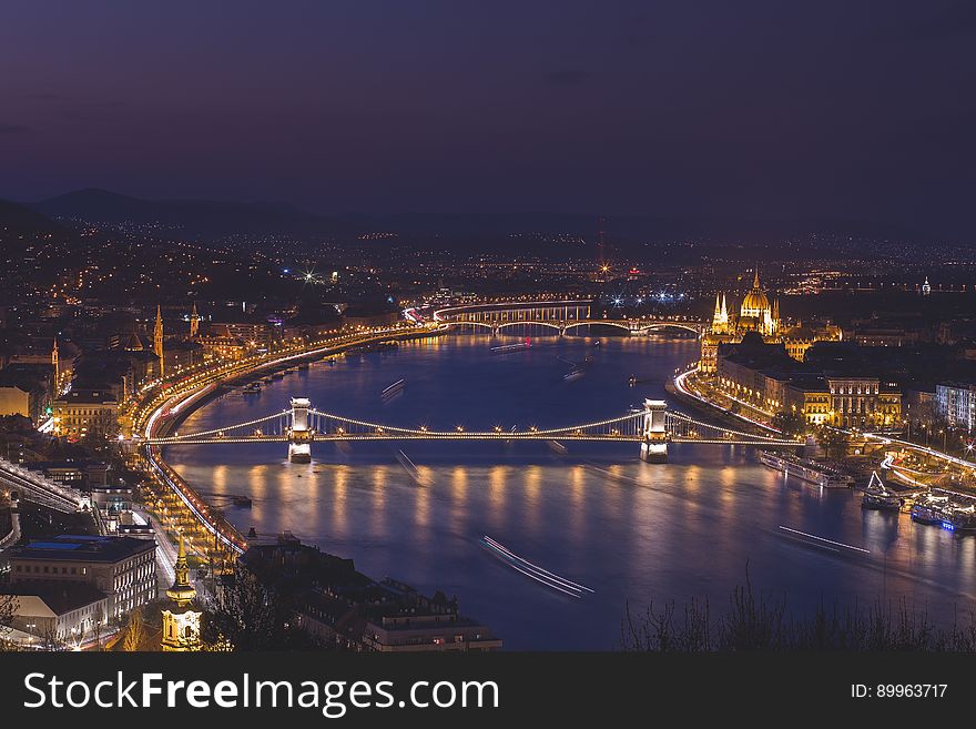 A view over the city of Budapest and the river Danube at night. A view over the city of Budapest and the river Danube at night.