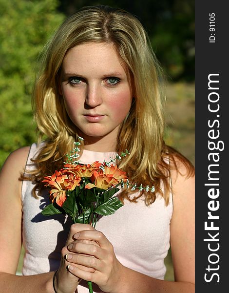 Young woman holding orange flowers. Young woman holding orange flowers