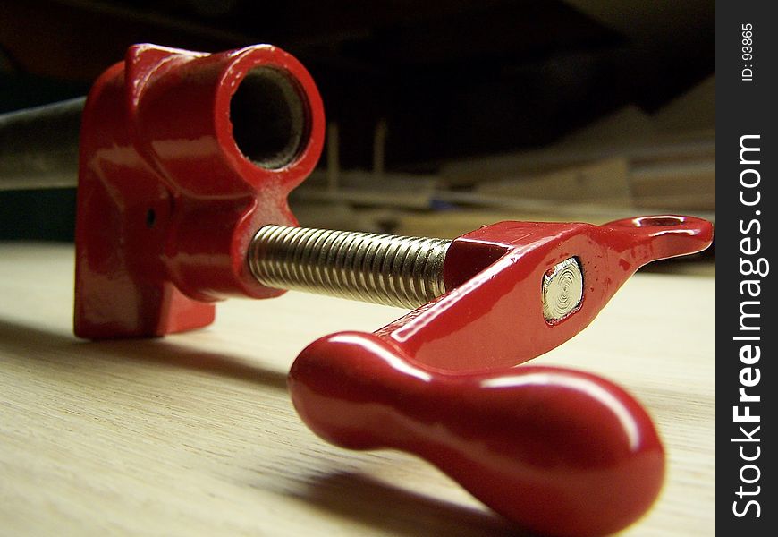 Closeup of handle and threads of a pipe clamp