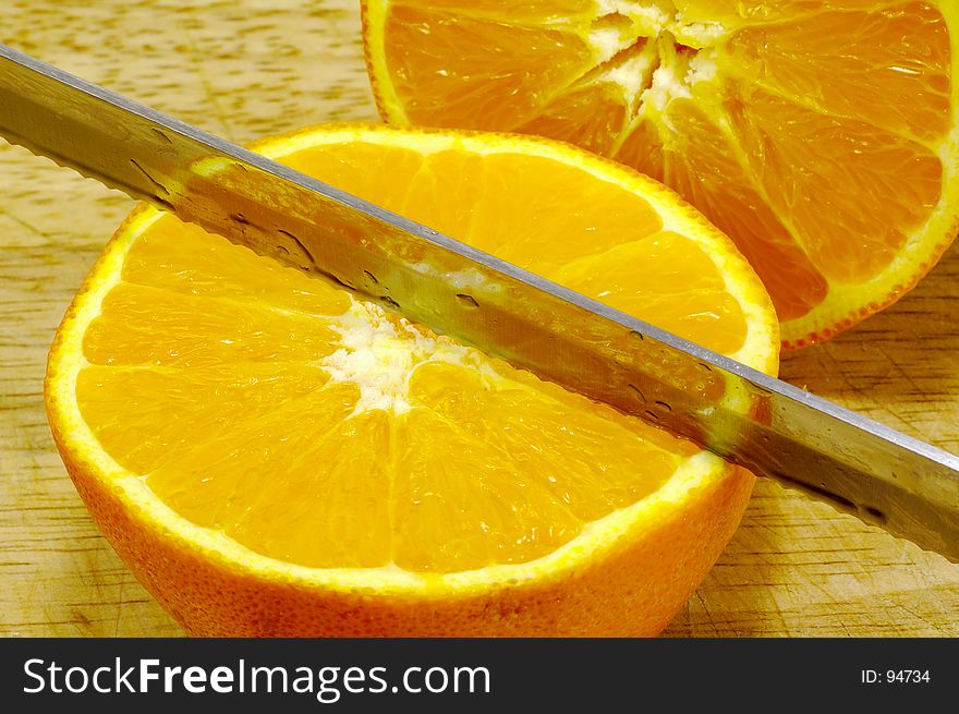 Sliced Orange on a Cutting Board With a Knife. Sliced Orange on a Cutting Board With a Knife.