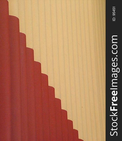 Corrugated steel wall background, yellow and brick color. Corrugated steel wall background, yellow and brick color