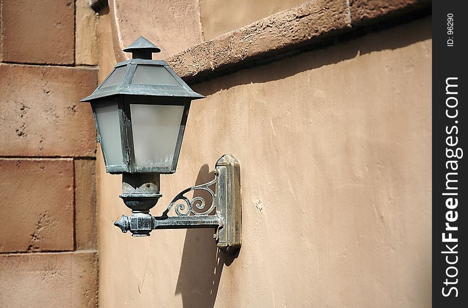 Old type light fixture on outside wall. Old type light fixture on outside wall