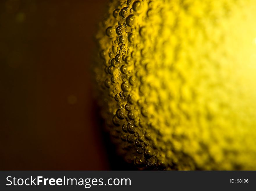 Air bubbles on the surface of an egg in yellow paint (easter theme). Shallow DOF. Air bubbles on the surface of an egg in yellow paint (easter theme). Shallow DOF.