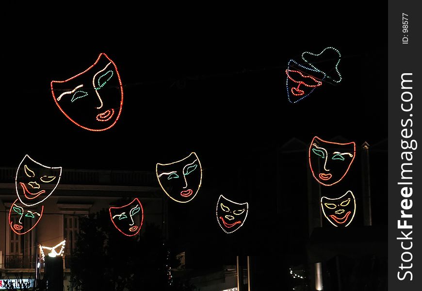 Illuminated carnival masks hunging over the street. Illuminated carnival masks hunging over the street