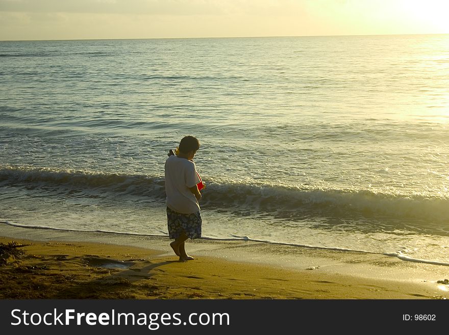 Young kid at the beach eary in the morning. Young kid at the beach eary in the morning