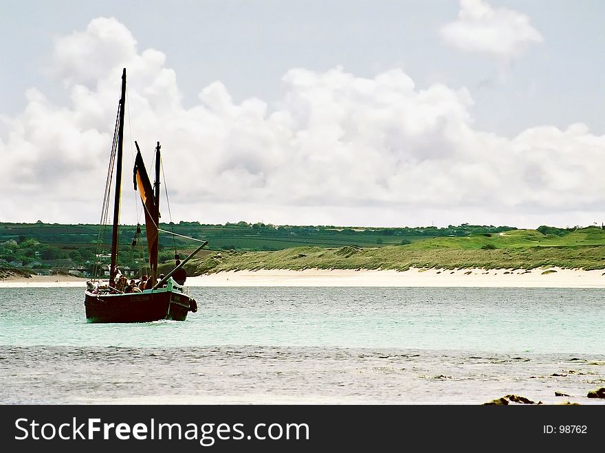 A sailing boat in the bay at St Ives, Cornwall, England, UK