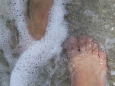 Couples`s Feet In Water Waves Stock Photo