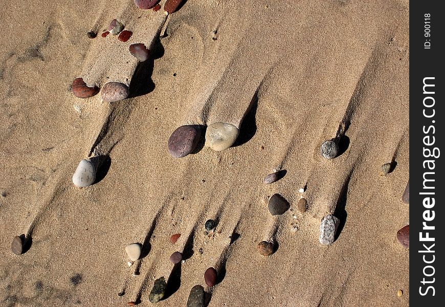 Sea, sand and varicoloured stones. Sea, sand and varicoloured stones.