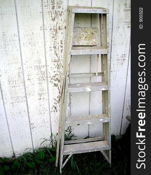 Old ladder leaning on old barn.