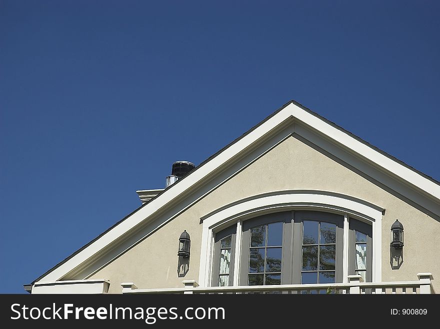 Home rooftop against a blue sky. Home rooftop against a blue sky