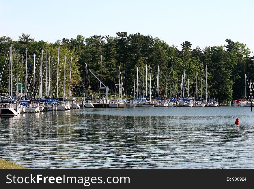 Summertime photo of sailboats docked in the harbor. Summertime photo of sailboats docked in the harbor.