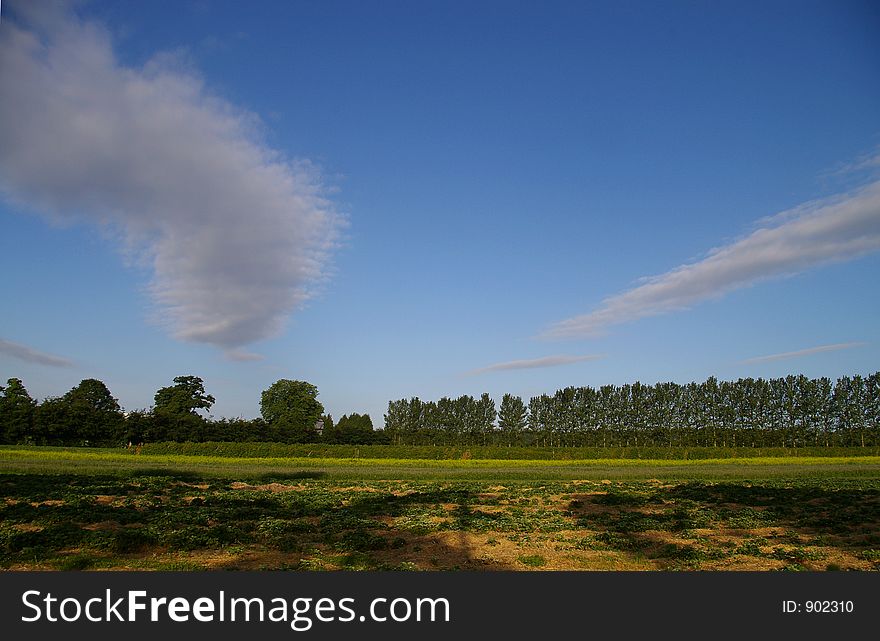 Two cloud streams over British farmland