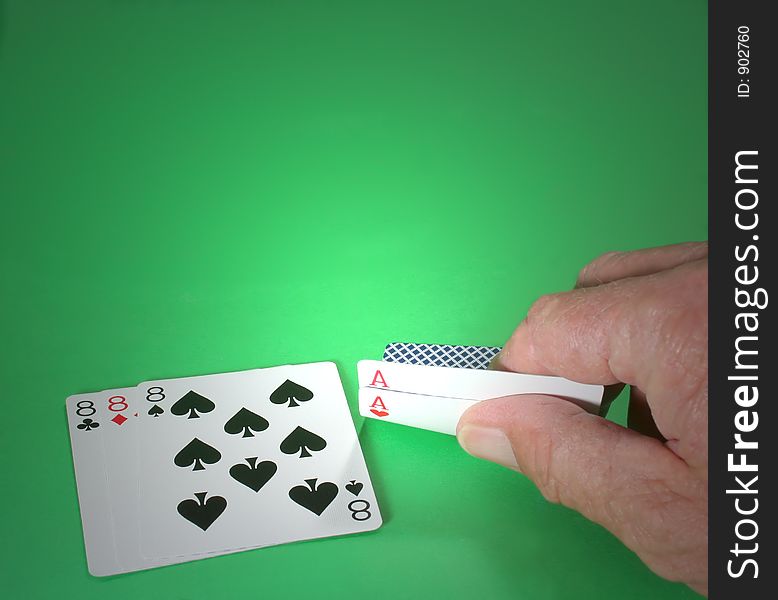 A man's hand showing two facedown cards in poker (card game). A man's hand showing two facedown cards in poker (card game)