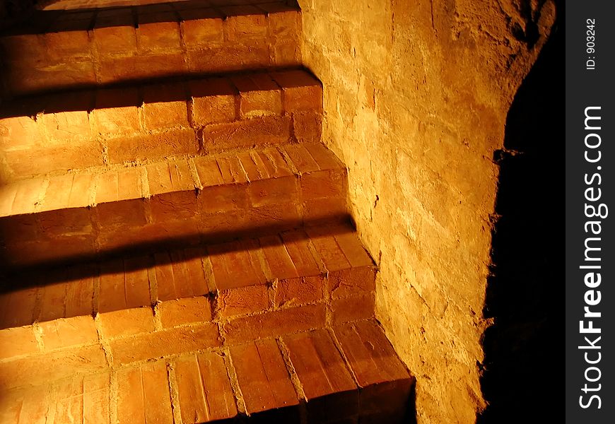 Stone stairs lit up in yellow.