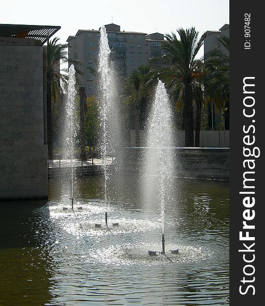 Three water spurts in an artificial lake in a park