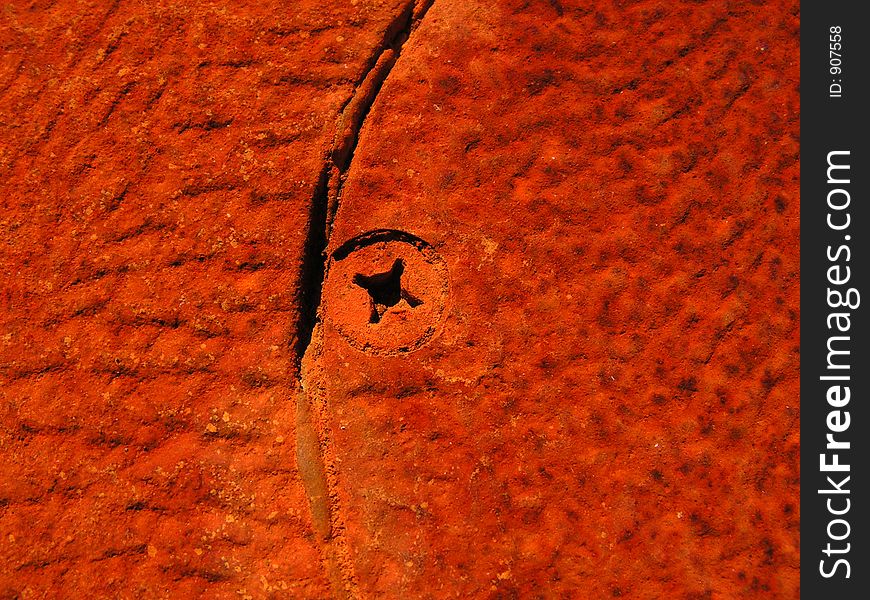 A old wood burner with rust texture and a rusted in screw head. A old wood burner with rust texture and a rusted in screw head.