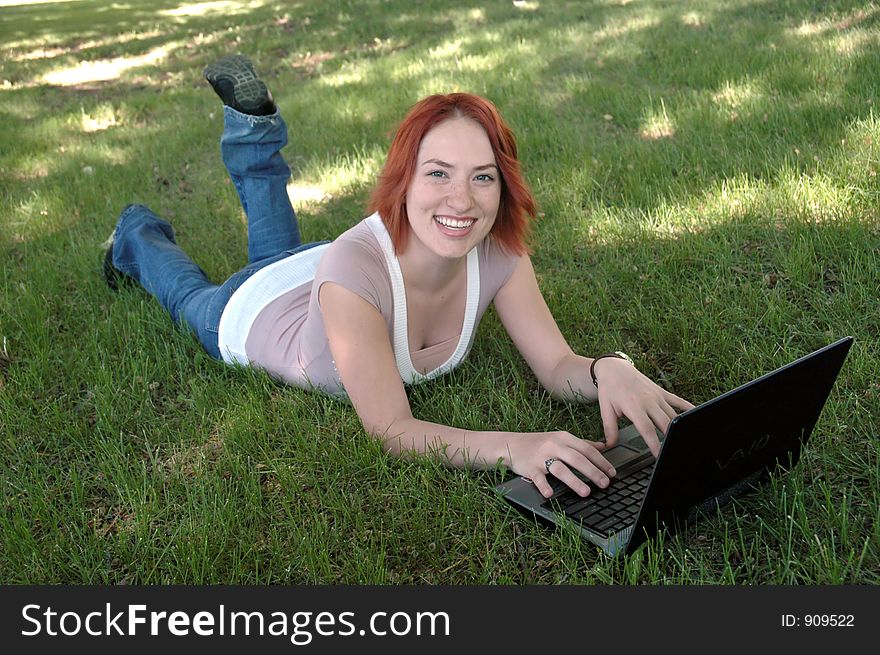 Pretty girl in park with laptop. Pretty girl in park with laptop.